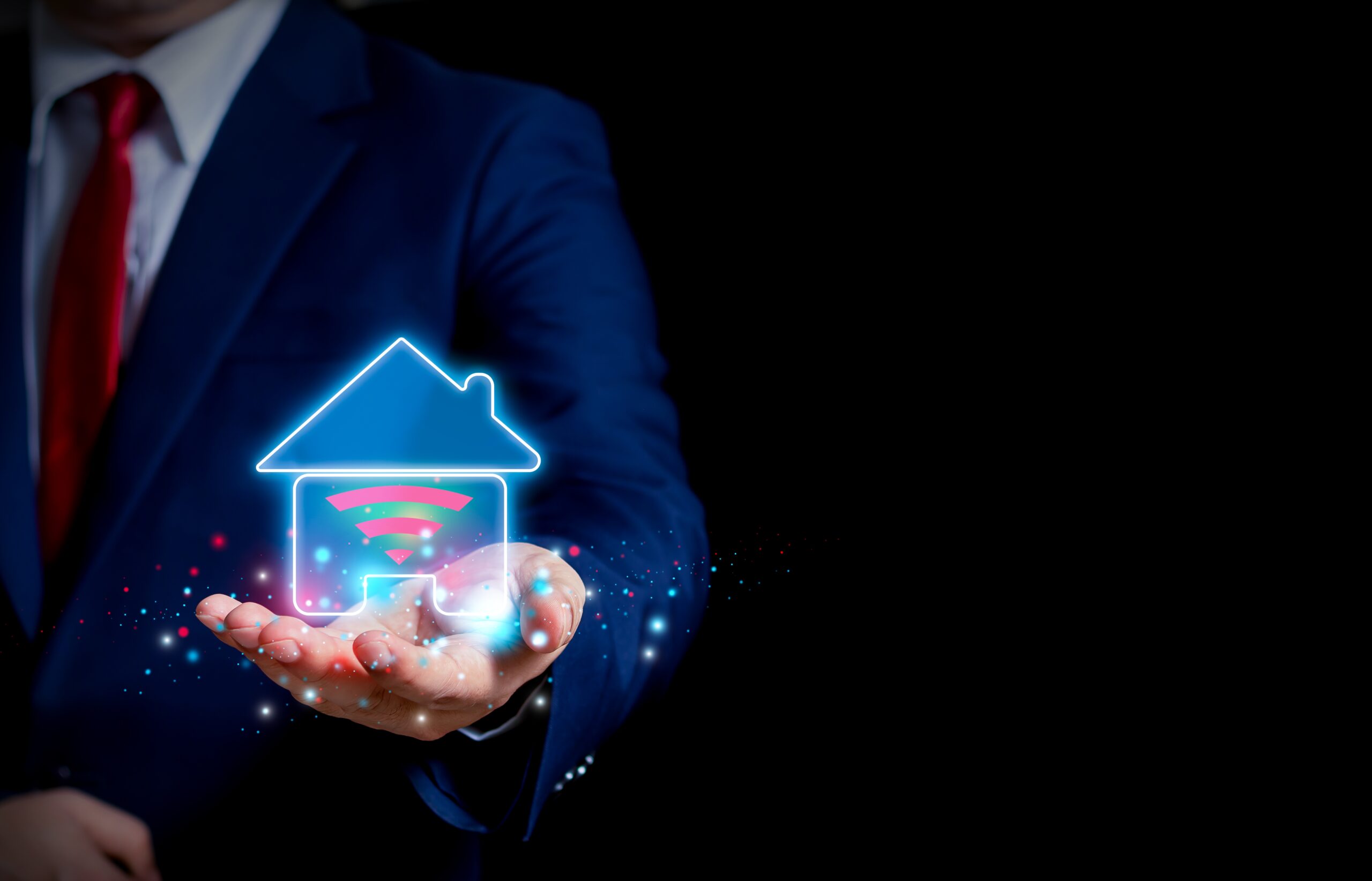 Businessman presenting a smart home technology concept with a glowing house icon and Wi-Fi symbol in his hand.